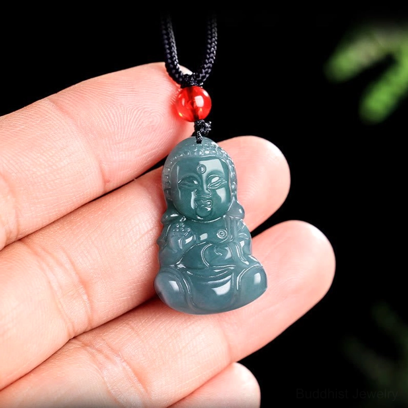 Jade Baby Buddha pendant held in fingertips showing actual size and craftsmanship details