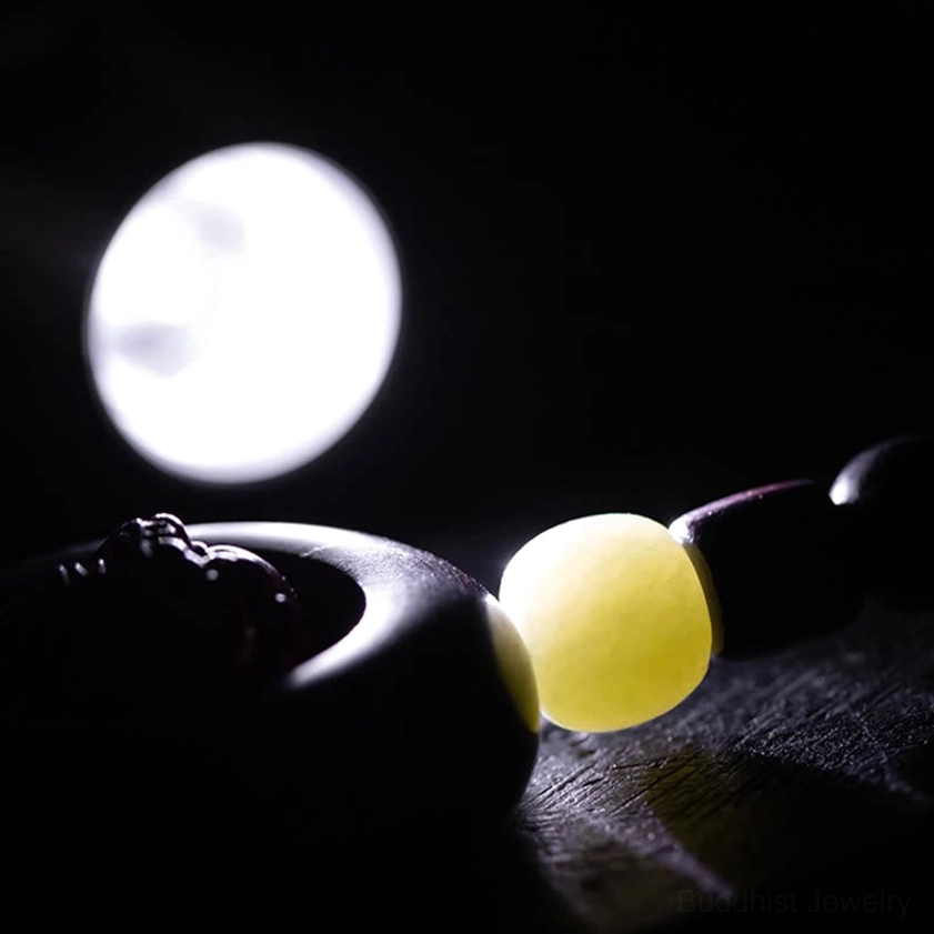 Buddhist keychain jade bead detail with protective spiritual energy focus in close-up lighting