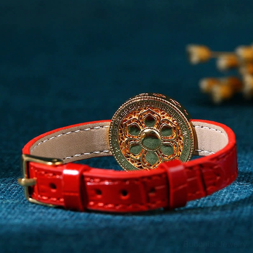 Bottom view showing adjustable buckle closure on red croc-texture leather Buddhist prosperity bracelet with gold charm and jade