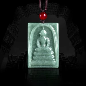 Jade Buddha square amulet pendant front overhead view, hand-carved formless Buddha design on natural bean-green jade with red bead cord