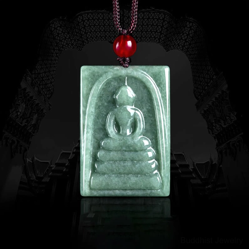 Jade Buddha square amulet pendant front overhead view, hand-carved formless Buddha design on natural bean-green jade with red bead cord