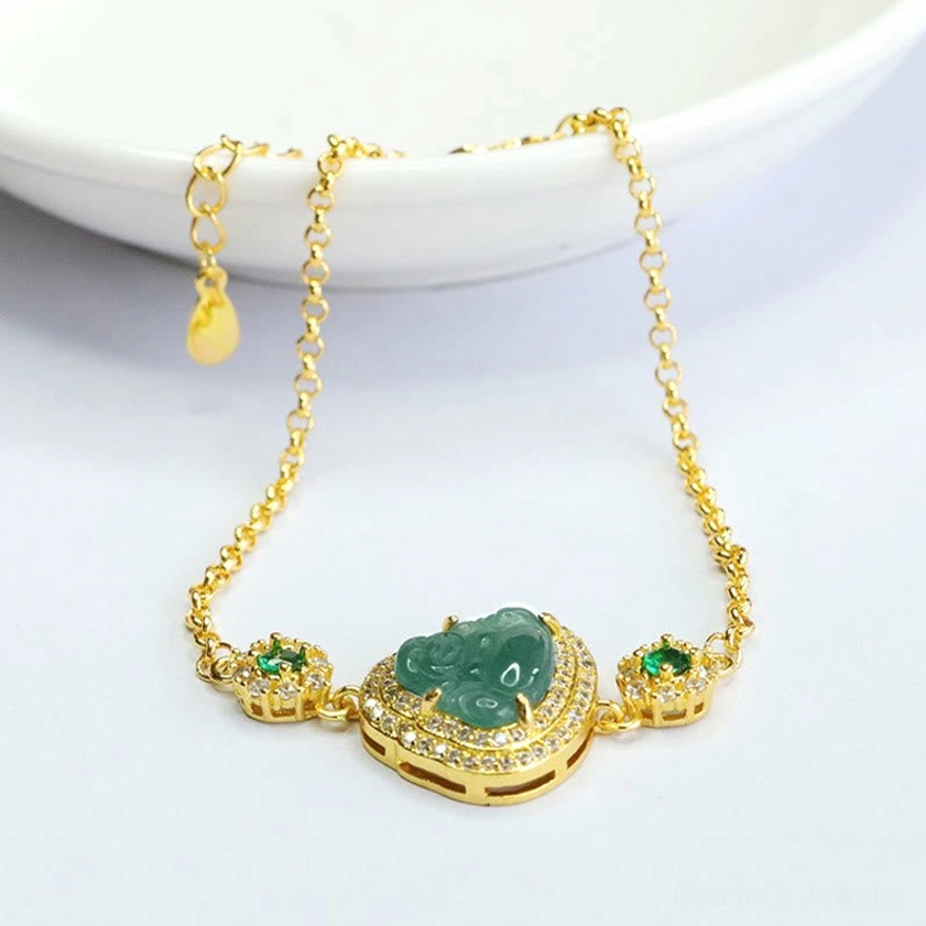 Buddhist jade prosperity bracelet with Laughing Buddha charm and adjustable extender chain displayed on ceramic bowl