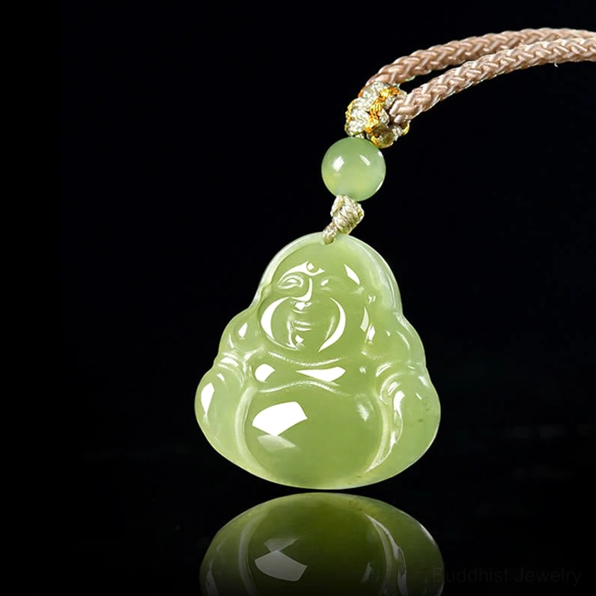 Laughing Buddha jade pendant necklace overhead view with reflective surface, displaying smooth green jade carving and woven rope cord from above