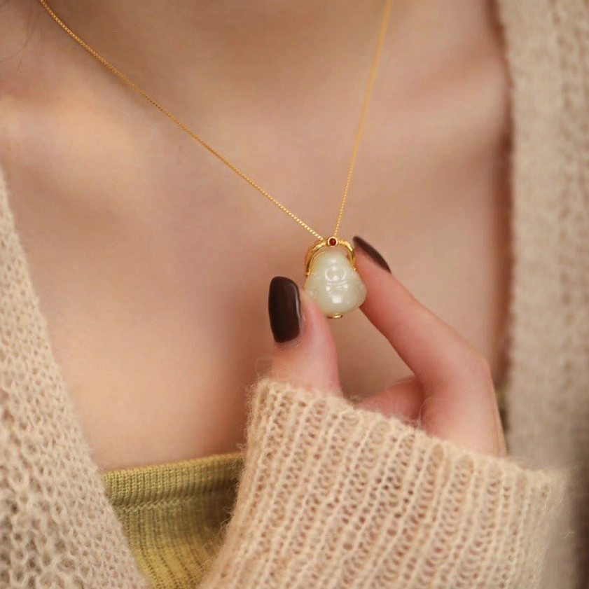 Hetian jade Laughing Buddha necklace worn on collarbone in casual daily outfit styling