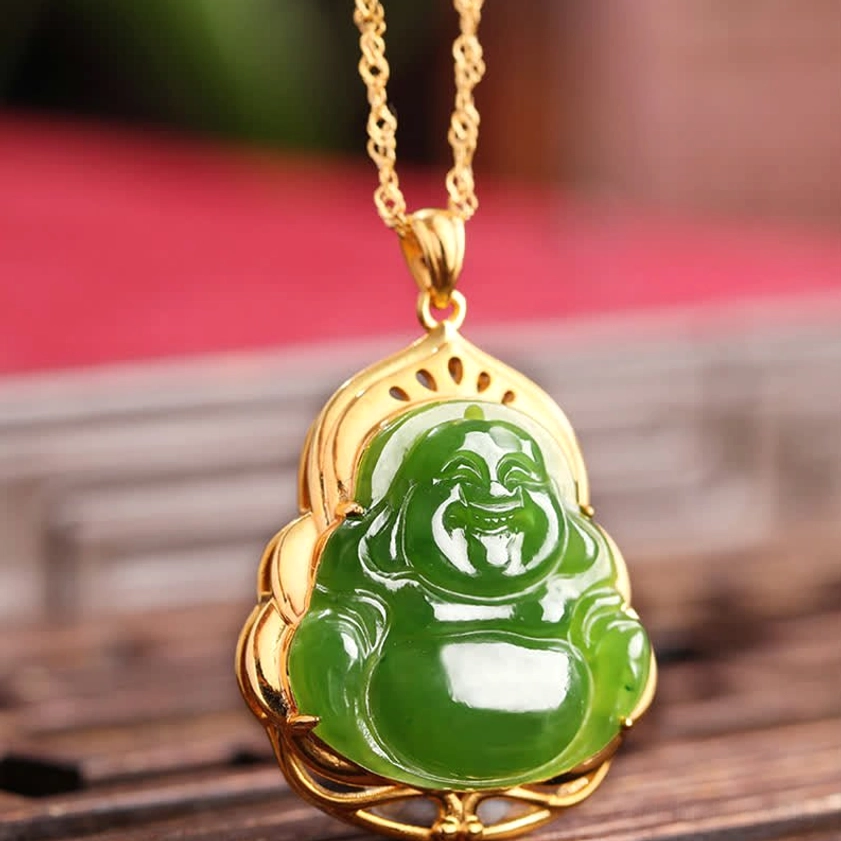 Hetian cyan jade Buddha pendant with hollowed gold border, close-up front view on wooden surface