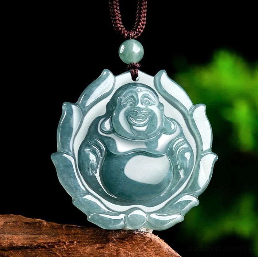 Close-up of natural jade laughing Buddha pendant showing carved details and smooth finish