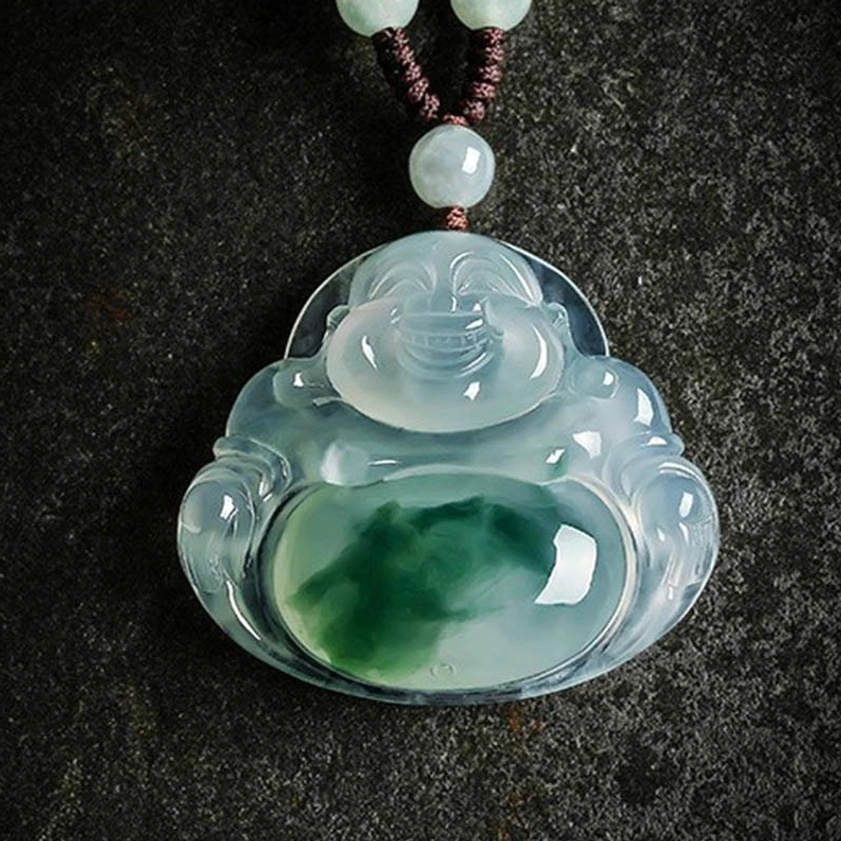 Premium cyan jade Buddhist pendant featuring carved laughing Buddha with green belly patch and natural jade veining on dark stone backdrop