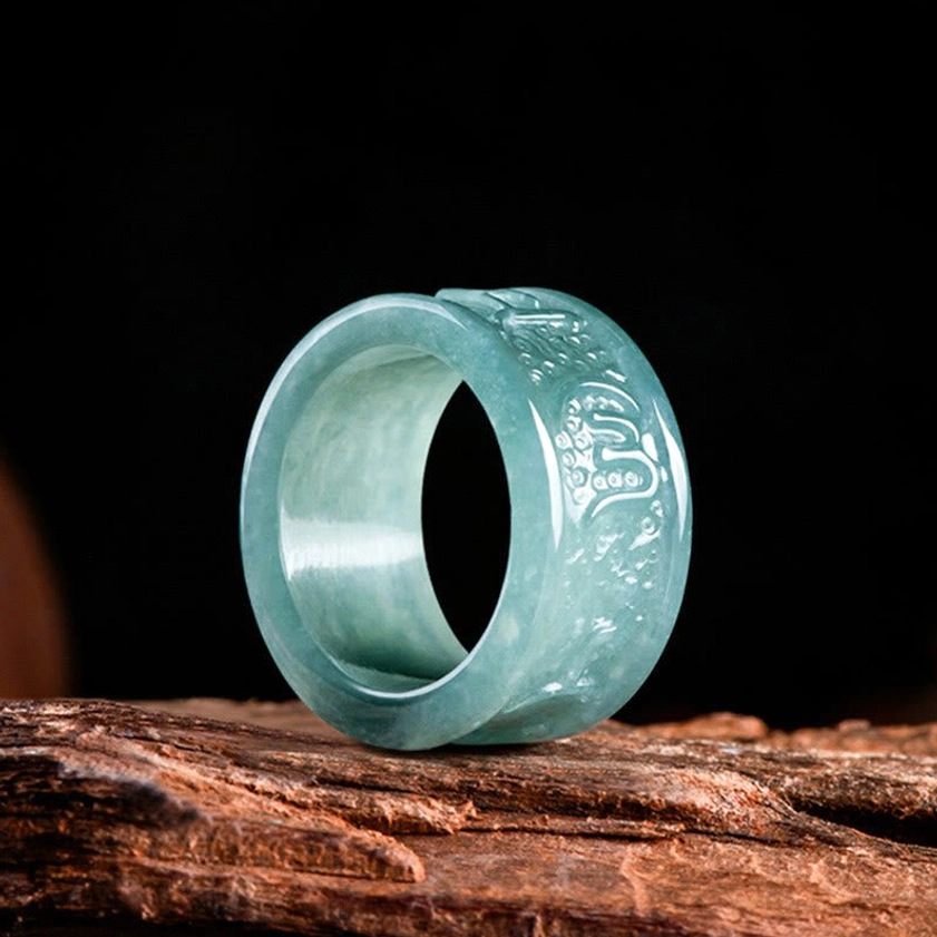 Front side view of hand-carved jade Buddhist ring featuring sacred Om Mani Padme Hum mantra, smooth polished surface with embossed spiritual carvings