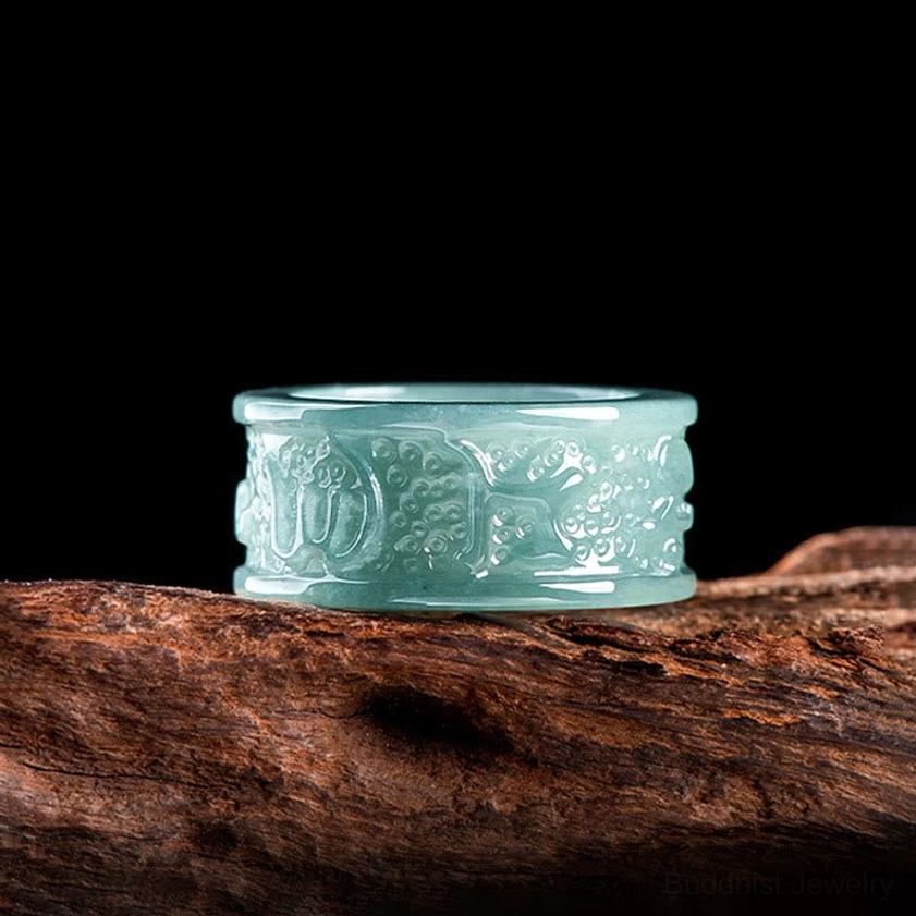 Top-down view of jade Om Mani Padme Hum ring showing complete outer engraved designs, intricate Buddhist mantra carvings on natural jade