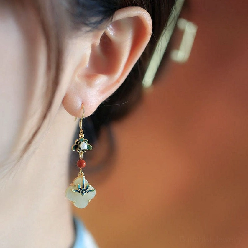 Close-up side view of jade four-leaf clover drop earrings being worn, demonstrating fit and drop length on ear