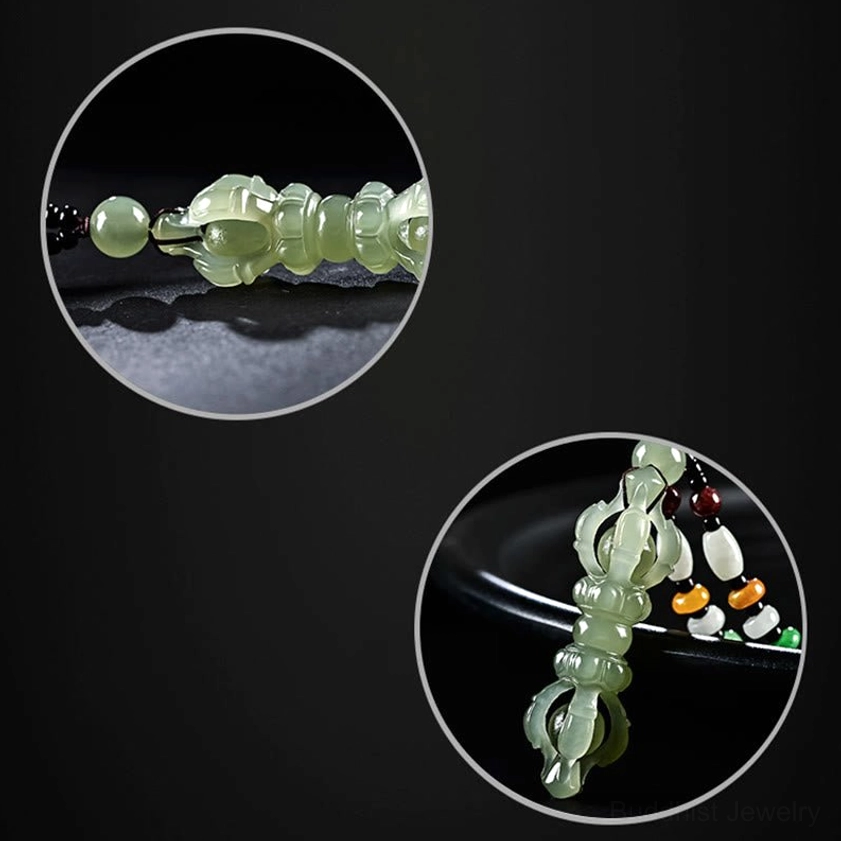 Close-up detail view of Hetian jade Dorje Vajra pendant and braided lanyard with colorful beads on dark background
