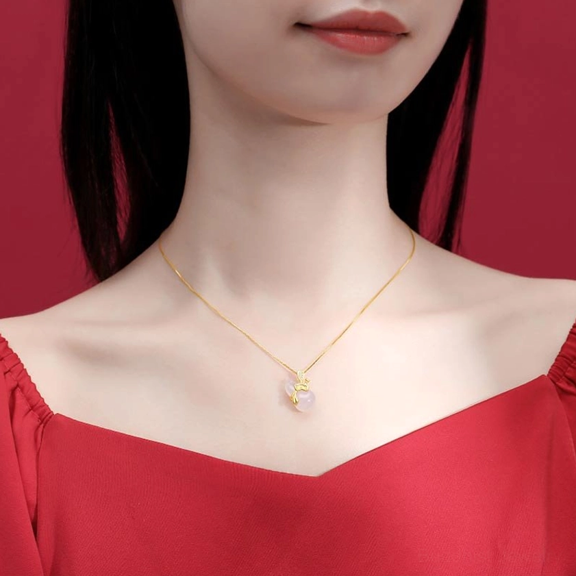 Woman wearing white jade gourd pendant necklace on adjustable gold chain, lifestyle shot with red off-shoulder clothing