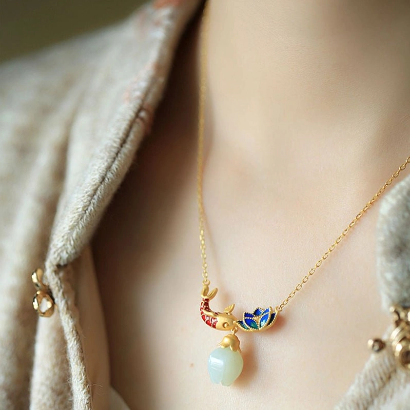 White jade koi fish lotus necklace worn on neck with delicate enamel ornament and slim gold chain paired with traditional Han clothing