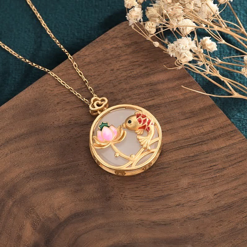 Koi fish lotus jade pendant necklace with gold chain side view on wooden board with floral styling