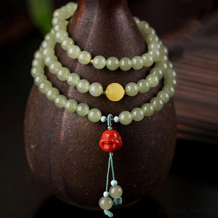 Jade prayer beads bracelet with laughing Buddha tassel pendant and light blue decorative beads on ceramic display stand