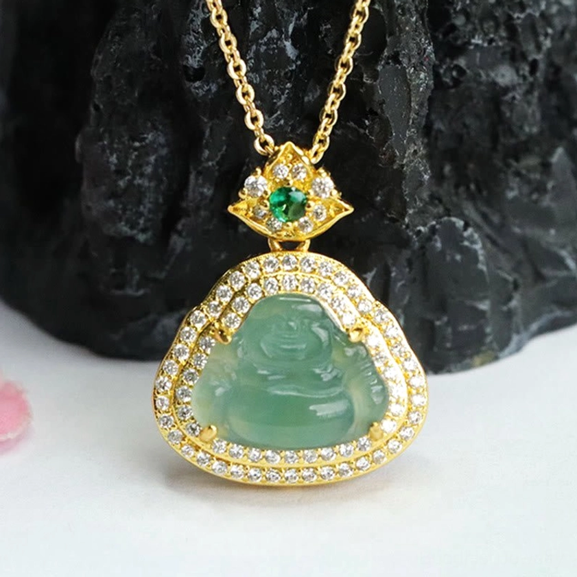 Overhead flat lay view of jade Laughing Buddha necklace with smooth translucent green jade and full CZ-encrusted gold setting