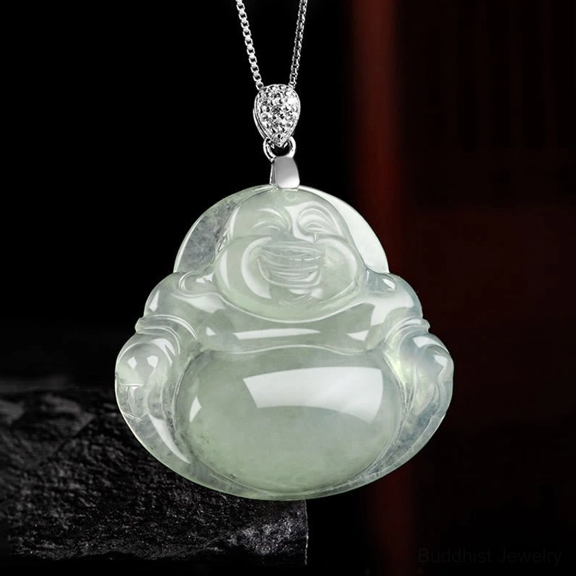 Laughing Buddha jade necklace pendant with decorative silver clasp and inlaid accents on dark background