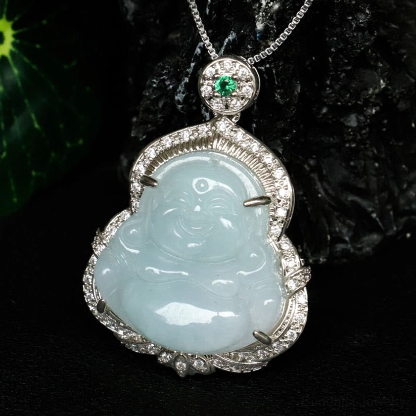 Close-up of smooth light blue jade Laughing Buddha pendant showing detailed facial features and silver crystal border