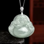 Natural light green jade Laughing Buddha pendant necklace front view with titanium steel chain on stone base