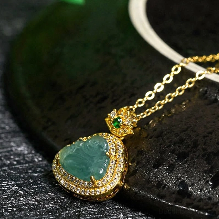 Three-quarter view of polished green jade Buddha pendant with sparkling gold metal frame