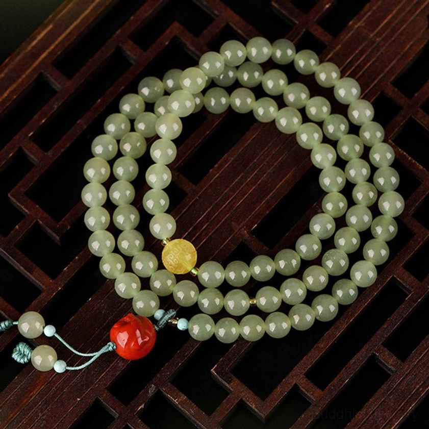 Jade laughing Buddha prosperity bracelet 108 beads with amber accents and red agate pendant lifestyle styling