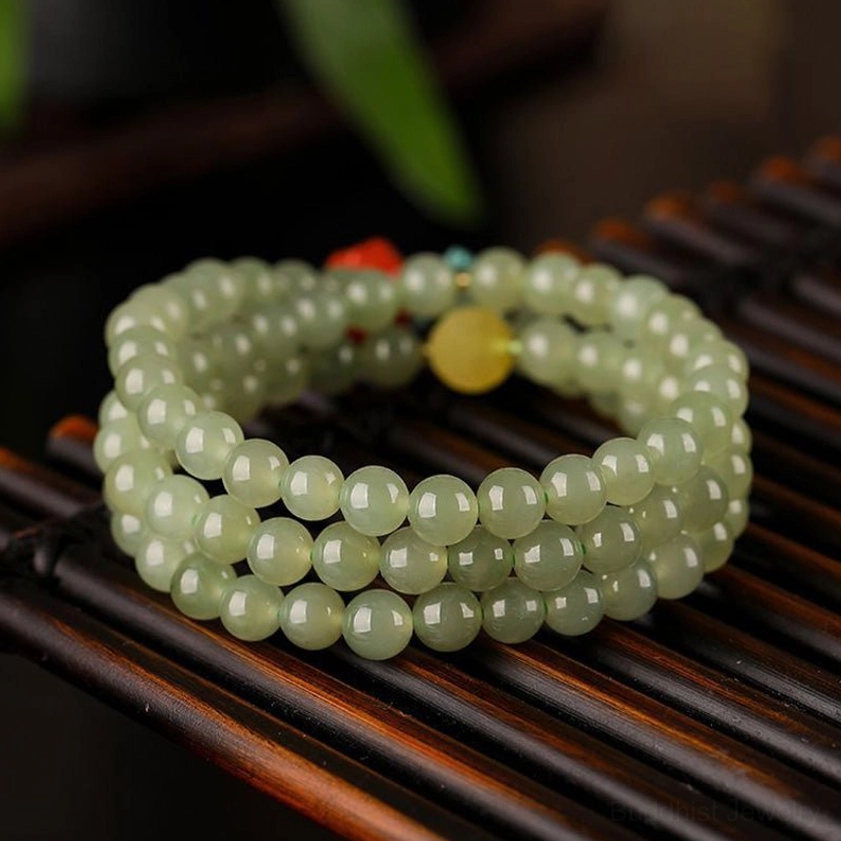 Triple-wrap jade laughing Buddha prosperity bracelet showing neat wrapped structure and polished round beads