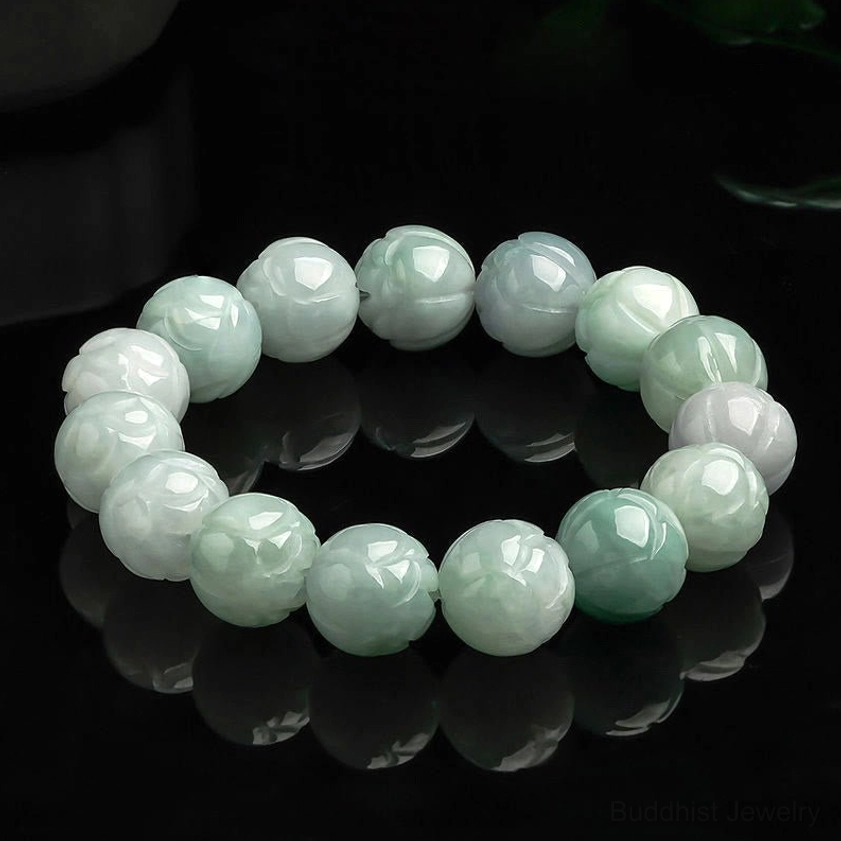 Natural jade lotus carving prosperity bracelet with carved lotus beads in light green and white jade tones on reflective black background