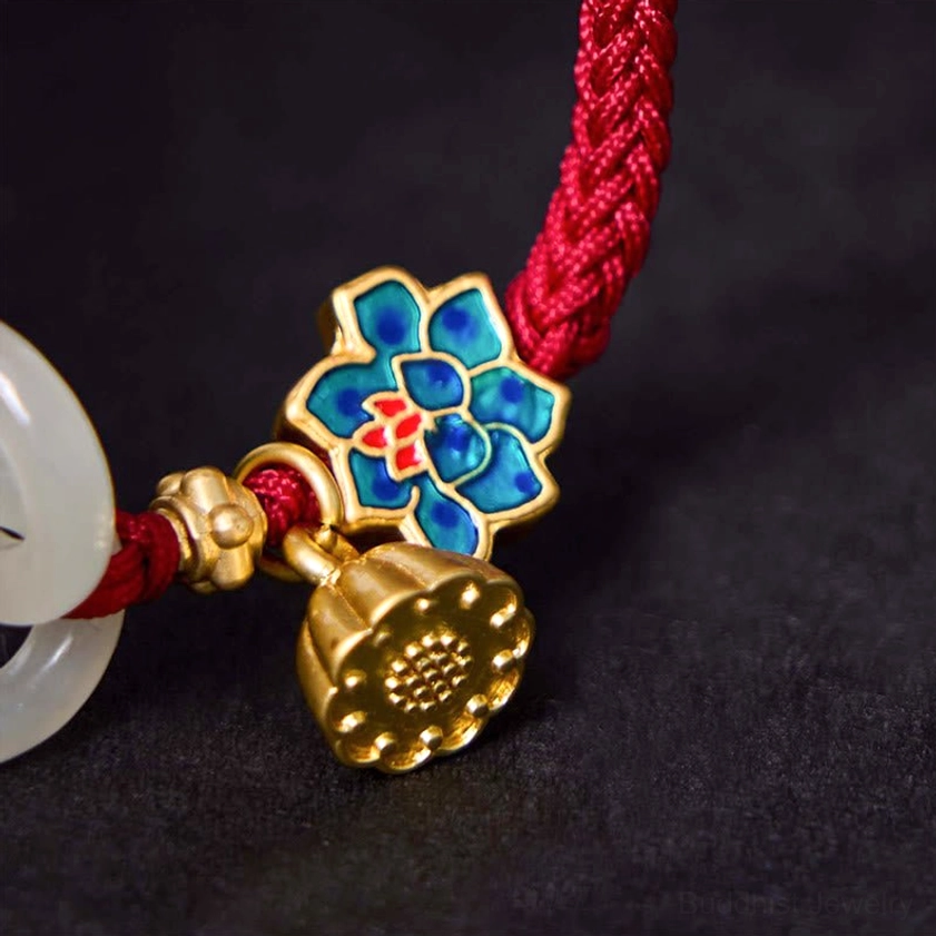 Detailed close-up of bracelet decorative elements including enamel lotus flower, gold lotus pendant, and red braided rope