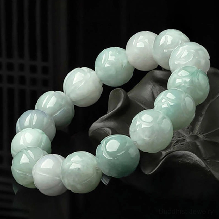 Pair of natural jade lotus bracelets with smooth polished beads and gradient green-white color on dark lotus-shaped base