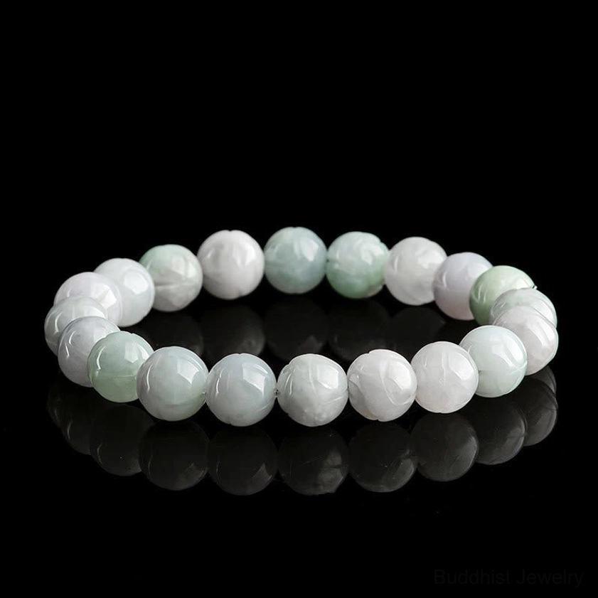 Round natural jade beads bracelet with light green to white gradient smooth polished surface on black reflective background