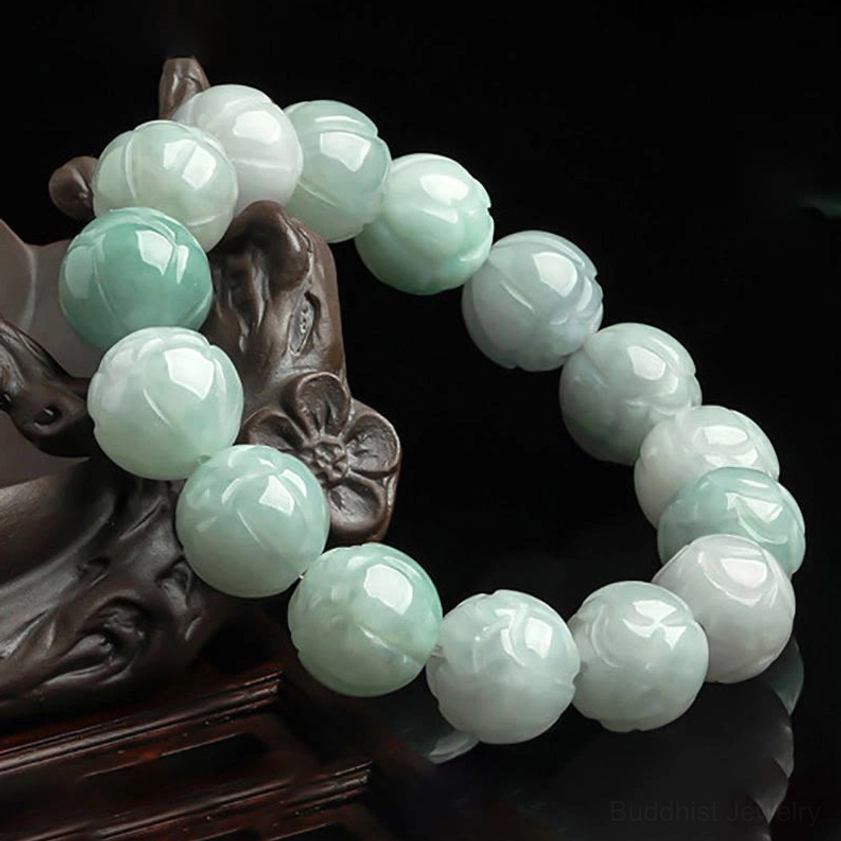 Stacked jade lotus bracelets displaying intricate hand-carved lotus flower design on wooden display stand