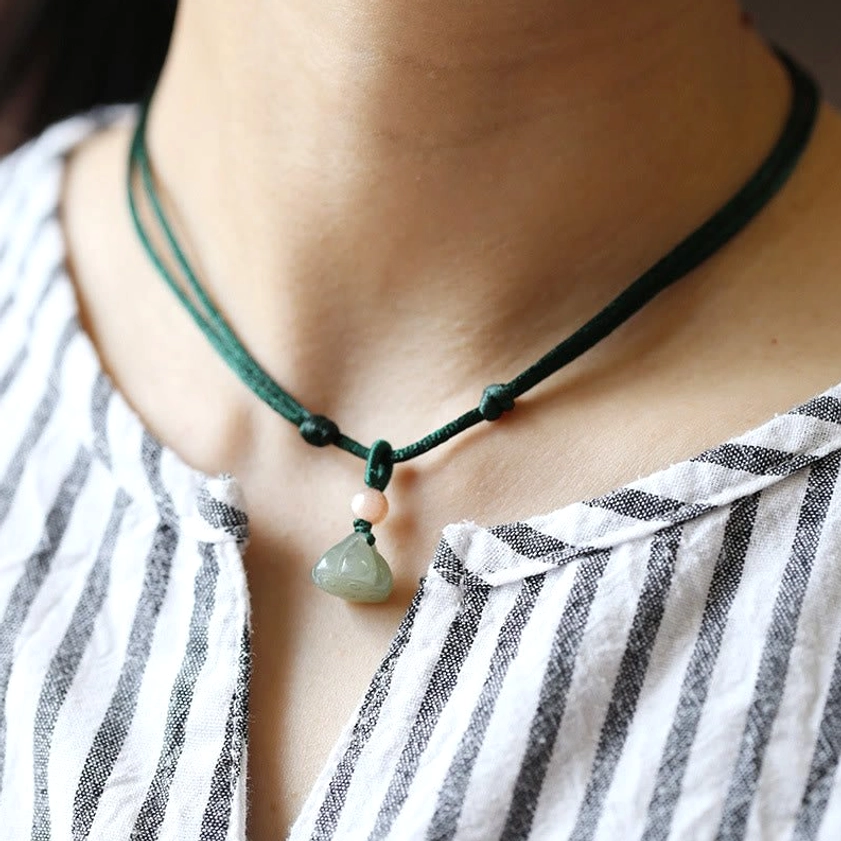 Double-strand dark green jade lotus pendant choker necklace worn on neck close-up front view
