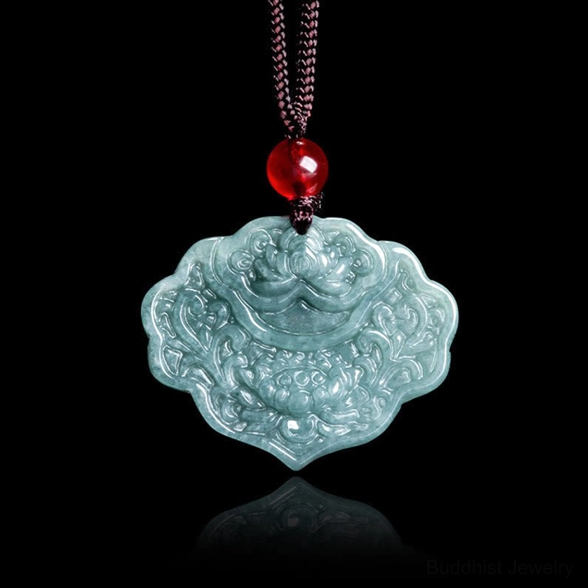 Carved jade lotus pendant displayed directly front-facing, showcasing detailed Buddhist floral motifs on bluish-green natural stone with brown cord