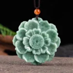 Hand-carved natural green jade lotus pendant necklace with brown cord and orange bead accent, Buddhist prosperity symbol