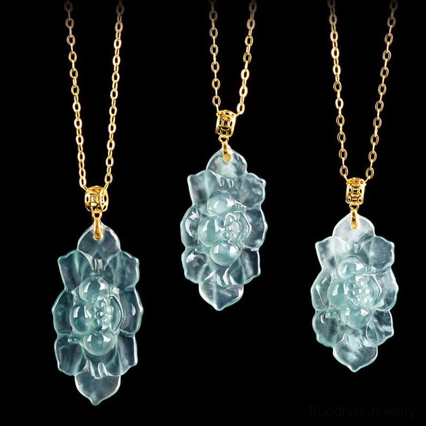 Flat lay top-down view of three matching natural jade lotus pendant necklaces displaying consistency of cyan-blue jade color and gold titanium steel chains