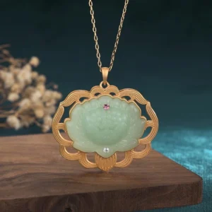 Natural jade lotus pendant necklace with gold-plated copper frame - front view showing carved light green jade lotus with dual gemstone accents, Buddhist prosperity pendant