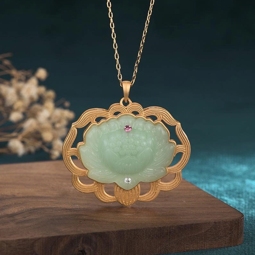 Natural jade lotus pendant necklace with gold-plated copper frame - front view showing carved light green jade lotus with dual gemstone accents, Buddhist prosperity pendant
