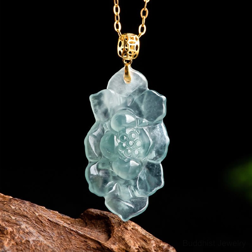 Close-up macro photograph of natural jade lotus pendant showing intricate hand-carved lotus pattern and smooth polished jade finish
