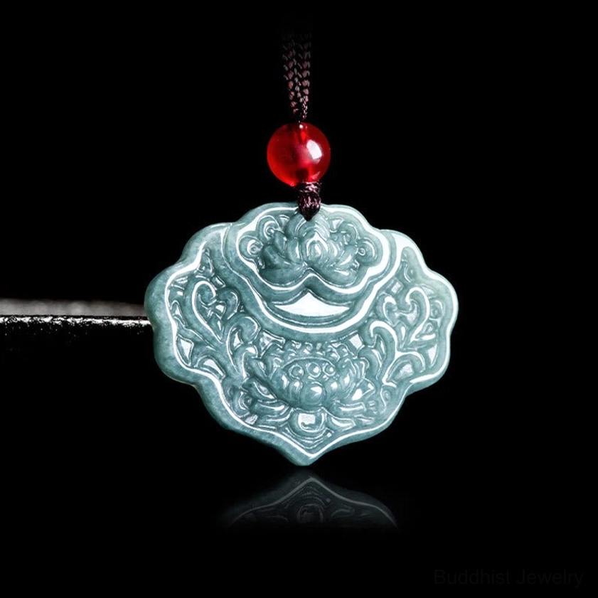 Jade lotus pendant necklace side three-quarter view on display rod, highlighting pendant depth and intricate carving details with protective red bead accent