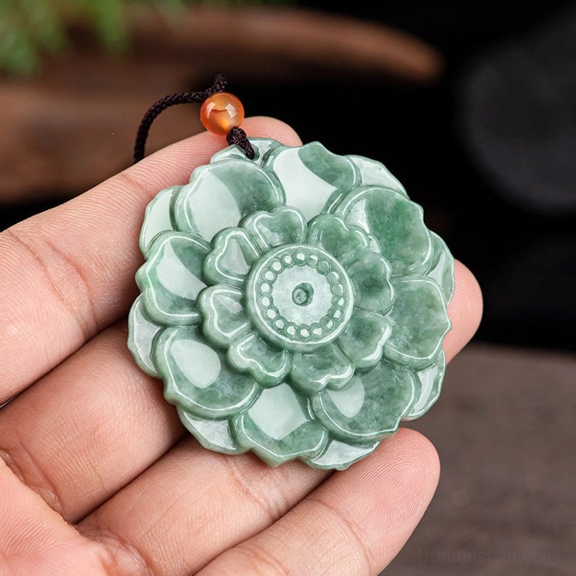 Close-up of hand-held jade lotus pendant showing size and detailed carving, 50.3mm diameter Buddhist symbol