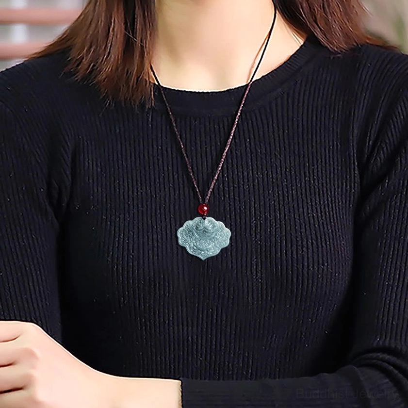 Wearable jade lotus pendant necklace worn close to neck, showing how the brown rope with red bead sits naturally on the body during daily wear