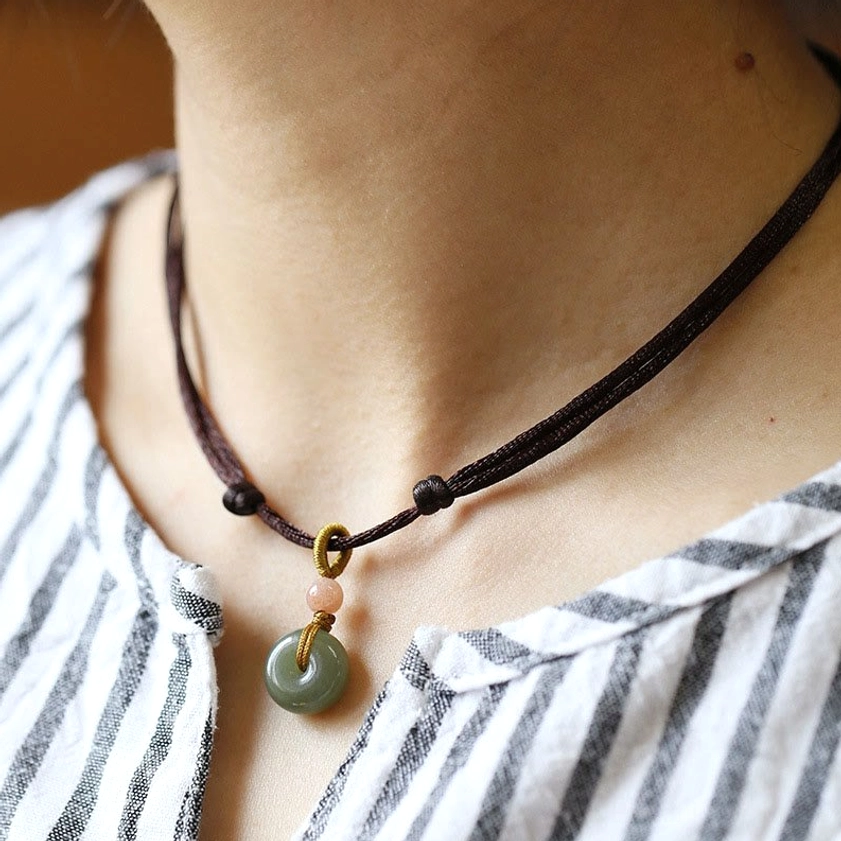 Brown cord jade peace buckle necklace variant showing natural jade pendant with accent bead