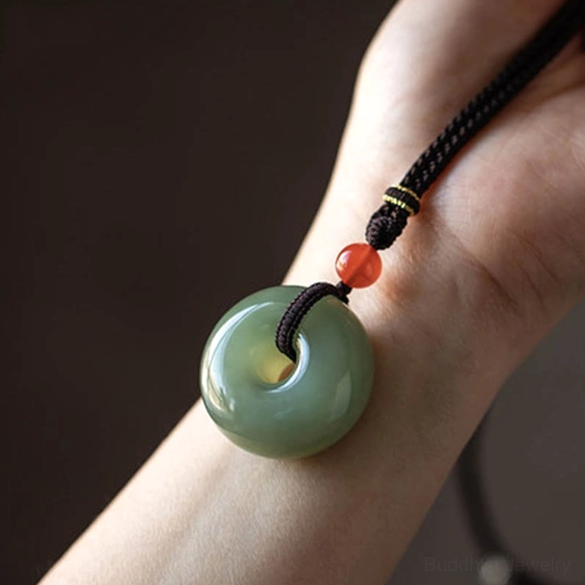 Natural jade peace buckle and lotus pendant necklace collection showing design variety