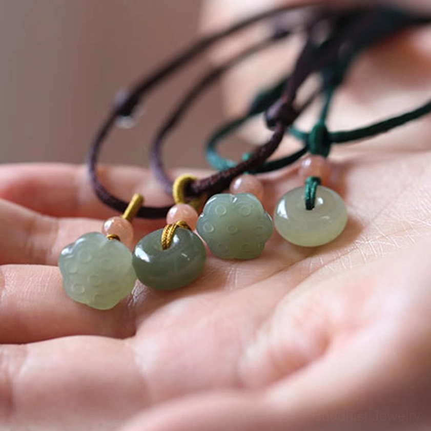 Natural jade peace buckle and lotus necklace showing cultural Buddhist symbolism detail