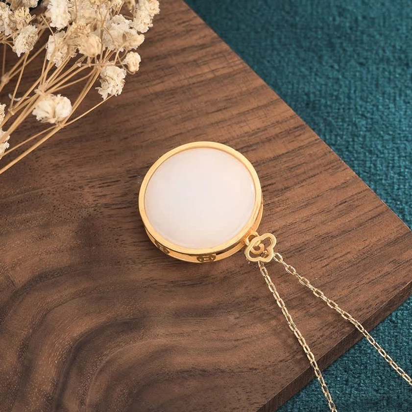 Reverse side of white jade pendant necklace showing smooth jade surface and cloud clasp