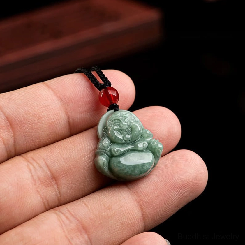 Hand-held natural green jade Laughing Buddha pendant showing actual size and proportions with black necklace cord