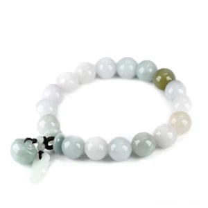 Natural jade beaded bracelet with mixed pale lavender and light green jade beads featuring two jade pendants, flat lay photography on white background