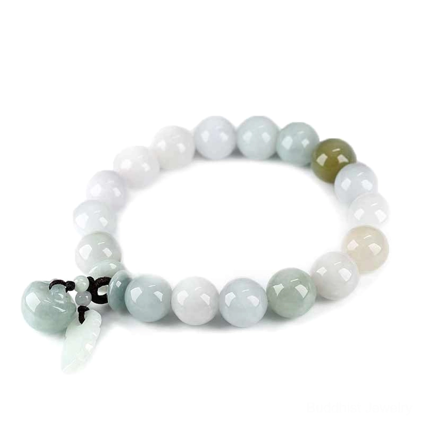 Natural jade beaded bracelet with mixed pale lavender and light green jade beads featuring two jade pendants, flat lay photography on white background
