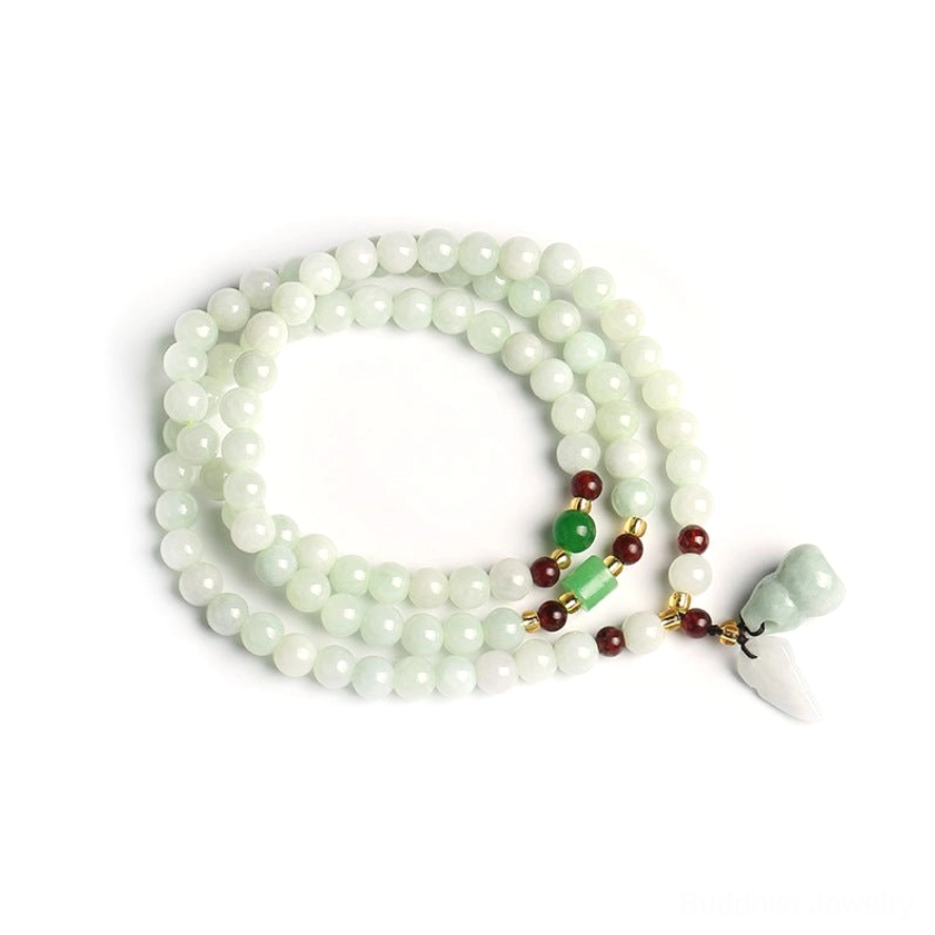 Overhead flat lay view of jade pixiu buddha bracelet with light green beads, matching jade pendant, and red accent beads on white background