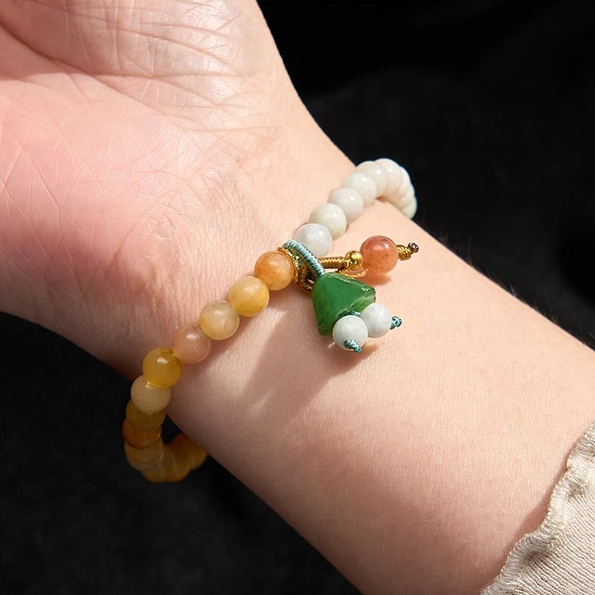 Wearable jade and quartzite beaded bracelet on human wrist, showing real-world wearing effect and comfort fit